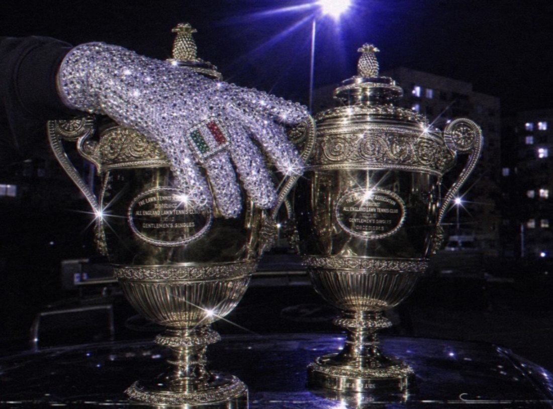 AI-generated image: a crystal glove resting on two silver trophies at night
